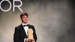 Barcelona's Spanish midfielder Gavi poses with the Kopa Trophy for best under-21 player during the 2022 Ballon d'Or France Football award ceremony at the Theatre du Chatelet in Paris on October 17, 2022. (Photo by FRANCK FIFE / AFP)