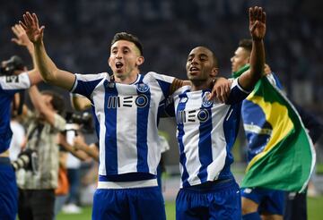 Porto's Mexican midfielder Hector Herrera (L) and Portuguese defender Ricardo Pereira celebrate after winning the league title following the Portuguese league football match between FC Porto and CD Feirense at the Dragao stadium in Porto on May 6, 2018.