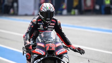 Aprilia Racing's Italian rider Marco Bezzecchi rips a strip off his visor during the free practice 1 session at the Buriram International Circuit in Buriram on February 27, 2026, ahead of the Thailand MotoGP Grand Prix. (Photo by Lillian SUWANRUMPHA / AFP)