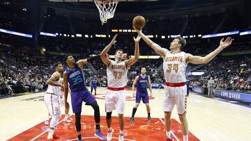Apr 11, 2017; Atlanta, GA, USA; Atlanta Hawks guard Mike Dunleavy (34) grabs a rebound past forward Kris Humphries (43) and Charlotte Hornets forward Christian Wood (35) in the second half at Philips Arena. The Hawks defeated the Hornets 103-76. Mandatory Credit: Brett Davis-USA TODAY Sports