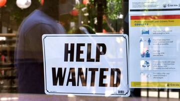 A 'Help Wanted' sign is poster at a restaurant in Los Angeles, California. - Fewer Americans filed unemployment benefit claims last week, government data said.