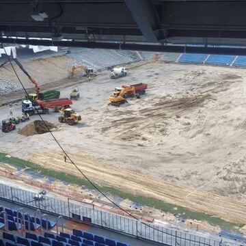 El interior del estadio del Real Madrid presenta durante estos días un aspecto muy diferente. Escombros y maquinaria son los protagonistas ahora sobre el césped del Bernabéu. El levantamiento del césped es ya casi total y en su lugar están los restos que dejan las máquinas en el proceso de remodelación.