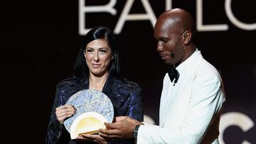 Spanish forward Jennifer Hermoso Fuentes (L) receives the Socrates Trophy for most involved player in societal and charitable projects from Ivorian former football player and evening host Didier Drogba during the 2024 Ballon d'Or France Football award ceremony at the Theatre du Chatelet in Paris on October 28, 2024. (Photo by FRANCK FIFE / AFP)