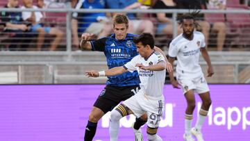 Jul 1, 2023; Stanford, California, USA; Los Angeles Galaxy midfielder Riqui Puig (6) dribbles against San Jose Earthquakes midfielder Jack Skahan (left) during the first half at Stanford Stadium. Mandatory Credit: Darren Yamashita-USA TODAY Sports