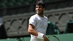 Spain's	Carlos Alcaraz smiles as he takes part in a warm up session at the All England Lawn Tennis Club in west London on June 27, 2024, the week before the Wimbledon Championships tennis tournament is due to start on July 1. (Photo by Ben Stansall / AFP) / RESTRICTED TO EDITORIAL USE