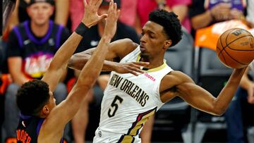 Apr 19, 2022; Phoenix, Arizona, USA; New Orleans Pelicans forward Herbert Jones (5) passes the ball against Phoenix Suns guard Devin Booker (1) during the first quarter during game two of the first round for the 2022 NBA playoffs at Footprint Center. Mandatory Credit: Mark J. Rebilas-USA TODAY Sports