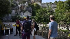 SIRACUSA, ITALY - AUGUST : General view of tourists visiting the Neapolis Archaeological Park on August , 2021 in Siracusa, Italy. Recognized as the true attraction of Syracuse, the Archaeological Park of Neapolis contains famous masterpieces from both Gr