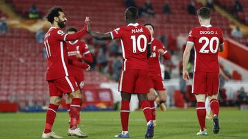 LIVERPOOL, ENGLAND - DECEMBER 06: Sadio Mane of Liverpool celebrates with Mohamed Salah and Diogo Jota after Nelson Semedo of Wolverhampton Wanderers scores Liverpools fourth goal (Own Goal) during the Premier League match between Liverpool and Wolverhamp