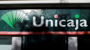 FILE PHOTO: The logo of Unicaja bank is seen on the facade of a Unicaja bank branch in downtown Ronda, southern Spain October 6, 2020. REUTERS/Jon Nazca/File Photo