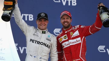 SOCHI, RUSSIA - APRIL 30: Race winner Valtteri Bottas of Finland and Mercedes GP celebrates with second placed finiser Sebastian Vettel of Germany and Ferrari on the podium during the Formula One Grand Prix of Russia on April 30, 2017 in Sochi, Russia. (Photo by Mark Thompson/Getty Images)