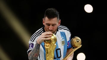 FILE PHOTO: Soccer Football - FIFA World Cup Qatar 2022 - Final - Argentina v France - Lusail Stadium, Lusail, Qatar - December 18, 2022 Argentina's Lionel Messi kisses the World Cup trophy after receiving the Golden Ball award as he celebrates after winning the World Cup REUTERS/Kai Pfaffenbach/File Photo