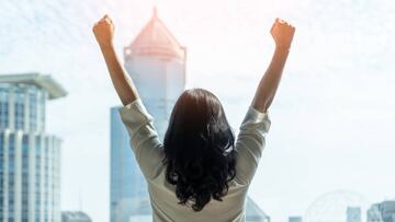 Woman power and girl strength in business achievement, winning and career success with strong businesswoman leader in office raising fists with ambition looking forward to city building background