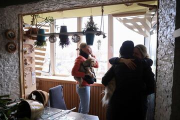 Residents of a residential building in Kyiv survey the damage caused by a Russian assault.