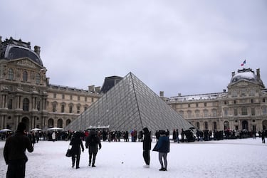 Personas esperan para entrar al Museo del Louvre tras una nevada.