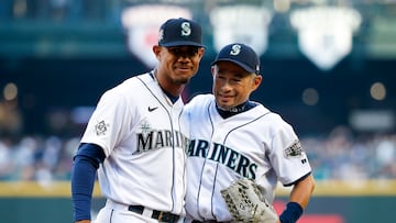 Apr 15, 2022; Seattle, Washington, USA; Seattle Mariners center fielder Julio Rodriguez (left) embraces former outfielder Ichiro Suzuki following a ceremonial first pitch by Suzuki before a game against the Houston Astros at T-Mobile Park. Mandatory Credit: Joe Nicholson-USA TODAY Sports