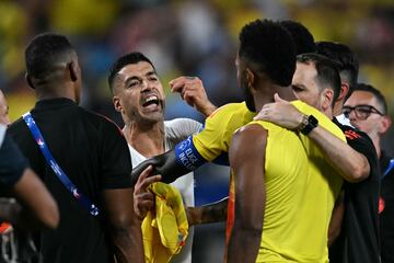 Uruguay's forward #09 Luis Suarez argues with Colombia's forward #09 Miguel Borja (R) at the end of the Conmebol 2024 Copa America tournament semi-final football match between Uruguay and Colombia at Bank of America Stadium, in Charlotte, North Caroline on July 10, 2024. (Photo by Chandan Khanna / AFP)