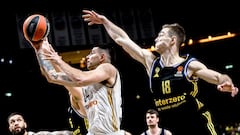 Gabriel Deck (L) of Real in action against Ziga Samar of Alba during the Euroleague Basketball match between Alba Berlin and Real Madrid, in Berlin, Germany, 19 March 2024.