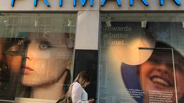 FILE PHOTO: A woman walks past a window display at a Primark store in Liverpool, Britain, September 15, 2021. REUTERS/Phil Noble/File Photo