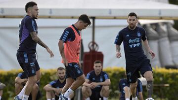 Argentina's forward Lionel Messi (R) transports the ball next to forward Paulo Dybala (C) and forward Lucas Ocampos during a training session in Ezeiza, Buenos Aires Province, on November 14, 2023, ahead of the FIFA World Cup 2026 qualifier football matches against Uruguay and Brazil. (Photo by Juan MABROMATA / AFP)