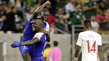 Haiti defender Carlens Arcus is held up by defender Andrew Jean Baptiste as Canada defender Mark-Anthony Kaye (14) walks off the field after Haiti defeated Canada 3-2 in a CONCACAF Gold Cup soccer quarterfinal Saturday, June 29, 2019, in Houston. (AP Photo/Michael Wyke)