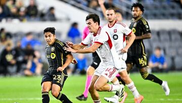 Oct 8, 2025; Los Angeles, California, USA; Los Angeles FC midfielder Frankie Amaya (23) passes the ball while pressured by Toronto FC midfielder Alonso Coello (14) during the second half at BMO Stadium. Mandatory Credit: Kelvin Kuo-Imagn Images