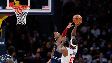 Jan 19, 2022; Denver, Colorado, USA; Los Angeles Clippers guard Eric Bledsoe (12) attempts a shot under pressure from Denver Nuggets guard Monte Morris (11) in the fourth quarter at Ball Arena. Mandatory Credit: Isaiah J. Downing-USA TODAY Sports