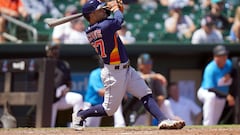 Mar 27, 2022; Jupiter, Florida, USA; Houston Astros second baseman Jose Altuve (27) hits a sacrifice fly in the third inning against the Miami Marlins during spring training at Roger Dean Stadium. Mandatory Credit: Jim Rassol-USA TODAY Sports