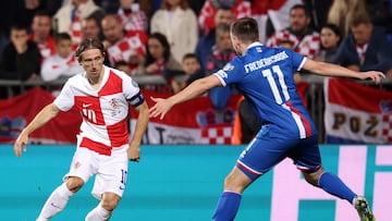 Croatia's midfielder #10 Luka Modric (L) fights for the ball with Faroe's midfielder #11 Arni Frederiksberg during the 2026 World Cup qualifiers Europe zone group L football match between Croatia and Faroe Islands at the Stadion HNK in Rijeka, on November 14, 2025. (Photo by AFP)