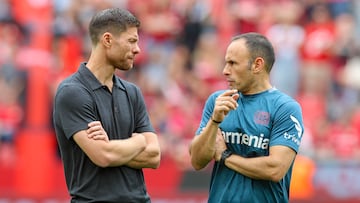 LEVERKUSEN, GERMANY - AUGUST 5: head coach Xabi Alonso of Bayer 04 Leverkusen and assistant coach Sebastian Parrilla of Bayer 04 Leverkusen talk together prior to the pre-season friendly match between Bayer 04 Leverkusen and West Ham United at BayArena on August 5, 2023 in Leverkusen, Germany. (Photo by Marco Steinbrenner/DeFodi Images via Getty Images)