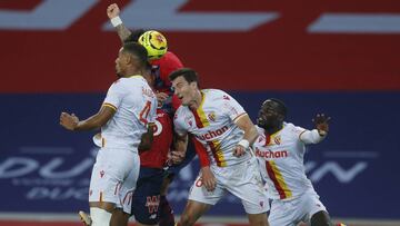 Lens' Loic Bade, left, and Manuel Perez, center, fight for the ball during their French League One soccer match between Lille and Lens in Villeneuve d'Ascq, northern France, Sunday Oct. 18, 2020. (AP Photo/Michel Spingler)