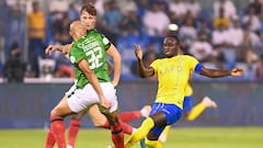 Nassr's Senegalese Forward #10 Sadio Mane fights for the ball with Ettifaq's Congolese defender #32 Marcel Tisserand during the Saudi Pro League football match between Al-Ettifaq and Al-Nassr at the Prince Mohamed bin Fahd Stadium in Dammam on August 14, 2023. (Photo by Ali Alhaji / AFP)