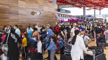 SCHOENEFELD, GERMANY - JULY 01: Passengers stand waiting to check in at Berlin Brandenburg Airport (BER) on July 01, 2021 in Schoenefeld, Germany. Germany is removing pandemic-related travel warnings for lower risk countries. The new policy does not apply