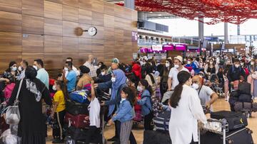 SCHOENEFELD, GERMANY - JULY 01: Passengers stand waiting to check in at Berlin Brandenburg Airport (BER) on July 01, 2021 in Schoenefeld, Germany. Germany is removing pandemic-related travel warnings for lower risk countries. The new policy does not apply