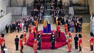 Members of the public file past the coffin of Queen Elizabeth II, draped in the Royal Standard with the Imperial State Crown and the Sovereign's orb and sceptre, lying in state.