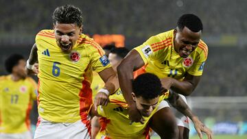 Colombia's forward #07 Luis Diaz (C) celebrates with teammates midfielder #06 Richard Rios and forward #11 Jhon Arias after scoring his team first goal during the 2026 FIFA World Cup South American qualifiers football match between Colombia and Paraguay at the Metropolitano Roberto Melendez stadium in Barranquilla, Colombia, on March 25, 2025. (Photo by Luis ACOSTA / AFP) (Photo by LUIS ACOSTA/AFP via Getty Images)