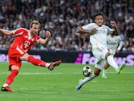Bayern Munich's English forward #09 Harry Kane (L) shoots challenged by Real Madrid's Brazilian defender #03 Eder Militao during the UEFA Champions League quarter final first leg football match between Real Madrid CF and FC Bayern Munich at Santiago Bernabeu Stadium in Madrid on April 7, 2026. (Photo by Pierre-Philippe MARCOU / AFP)
