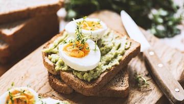 Healhy Breakfast Toast With Avocado, Boiled Egg On Wooden Cutting Board