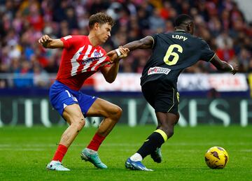 Soccer Football - LaLiga - Atletico Madrid v Almeria - Metropolitano, Madrid, Spain - December 10, 2023 Almeria's Dion Lopy in action with Atletico Madrid's Marcos Llorente REUTERS/Susana Vera