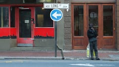 An informal car-guard stands before a closed bar and restaurant in Long Street, normally bustling with foreign tourists, as coronavirus disease (COVID-19) lockdown regulations ease in Cape Town, South Africa, August 24, 2020. Picture taken August 24, 2020