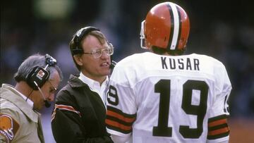 CLEVELAND, OH - CIRCA 1980's: Head Coach Marty Schottenheimer of the Cleveland Browns talks with his quarterback Bernie Kosar #19 on the sidelines during a mid circa 1980's NFL football game at Cleveland Municipal Stadium in Cleveland, Ohio. Schottenheimer was the head coach of the Cleveland Browns from 1984-88. (Photo by Focus on Sport/Getty Images)