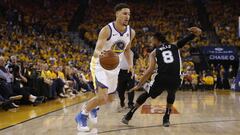 Apr 14, 2018; Oakland, CA, USA; Golden State Warriors guard Klay Thompson (11) dribbles past San Antonio Spurs guard Patty Mills (8) in the first quarter in game one of the first round of the 2018 NBA Playoffs at Oracle Arena. Mandatory Credit: Cary Edmondson-USA TODAY Sports