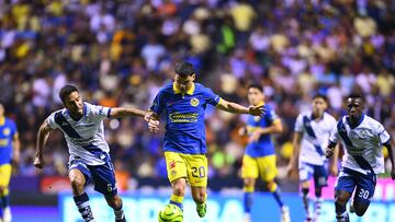Pablo Gonzalez (L) of Puebla fights for the ball with Richard Sanchez (R) of America during the 17th round match between Puebla and America as part of the Torneo Clausura 2024 Liga BBVA MX at Cuauhtemoc Stadium on April 26, 2024 in Puebla, Mexico.