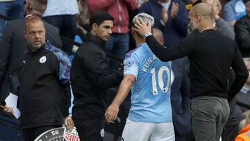 Manchester City's head coach Pep Guardiola, right, speaks with Manchester City's Sergio Aguero during the English Premier League soccer match between Manchester City and Tottenham Hotspur at Etihad stadium in Manchester, England, Saturday, Aug.