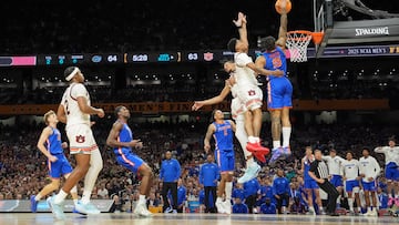 Apr 5, 2025; San Antonio, TX, USA; Florida Gators guard Alijah Martin (15) dunks the ball against Auburn Tigers guard Tahaad Pettiford (0) and guard Chad Baker-Mazara (10) during the second half in the semifinals of the men's Final Four of the 2025 NCAA Tournament at the Alamodome. Mandatory Credit: Bob Donnan-Imagn Images