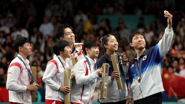 PARIS, FRANCE - JULY 30: Gold medalists, Chuqin Wang and Yingsha Sun of Team People’s Republic of China (C), silver medalists Jong Sik Ri and Kum Yong Kim of Team Democratic People’s Republic of Korea (L) and Bronze Medalists, Jonghoon Lim and Yubin Shin of Team Republic of Korea (R) pose for a selfie on the podium after the Table Tennis Mixed Doubles on day four of the Olympic Games Paris 2024 at South Paris Arena on July 30, 2024 in Paris, France. (Photo by Jared C. Tilton/Getty Images)