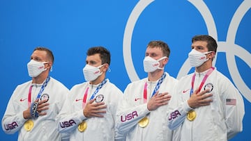 26 July 2021, Japan, Tokyo: USA Relay team swimmers Zach Apple, Blake Pieroni, Bowen Beck and Caeleb Dressel celebrate with gold medals at the award ceremony of the Men&#039;s swimming 4x100m Freestyle Relay final at the Tokyo Aquatics Centre during the T