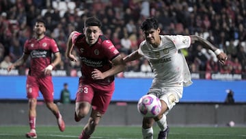 Tijuana's defender #03 Rafael Inzunza and Toluca's Paraguayan forward #31 Robert Morales fight for the ball during the Liga MX Apertura football match between Tijuana and Toluca at Caliente Stadium in Tijuana, Mexico, on October 22, 2025. (Photo by Guillermo Arias / AFP)