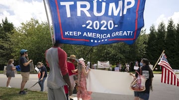 Supporters of and demonstrators against United States President Donald Trump gather in front of Trump National Golf Club in Sterling, Virginia. 