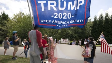 Supporters of and demonstrators against United States President Donald Trump gather in front of Trump National Golf Club in Sterling, Virginia.