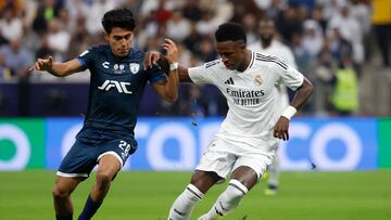 Real Madrid's Brazilian forward #7 Vinicius Junior is marked by Pachuca's Mexican midfielder #28 Elias Montiel during the 2024 FIFA Intercontinental Cup final football match between Spain's Real Madrid and Mexico's Pachuca at the Lusail Stadium in Doha on December 18, 2024. (Photo by KARIM JAAFAR / AFP)